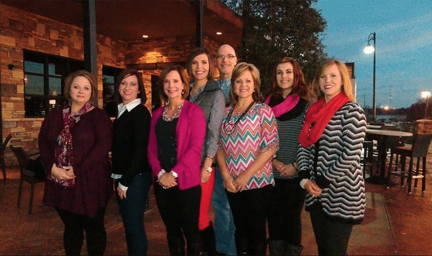 Dentist Muskogee OK Casey Fishburn, DMD With Team Outside In Evening Casey Fishburn, DMD With Team Standing Outside In Evening
